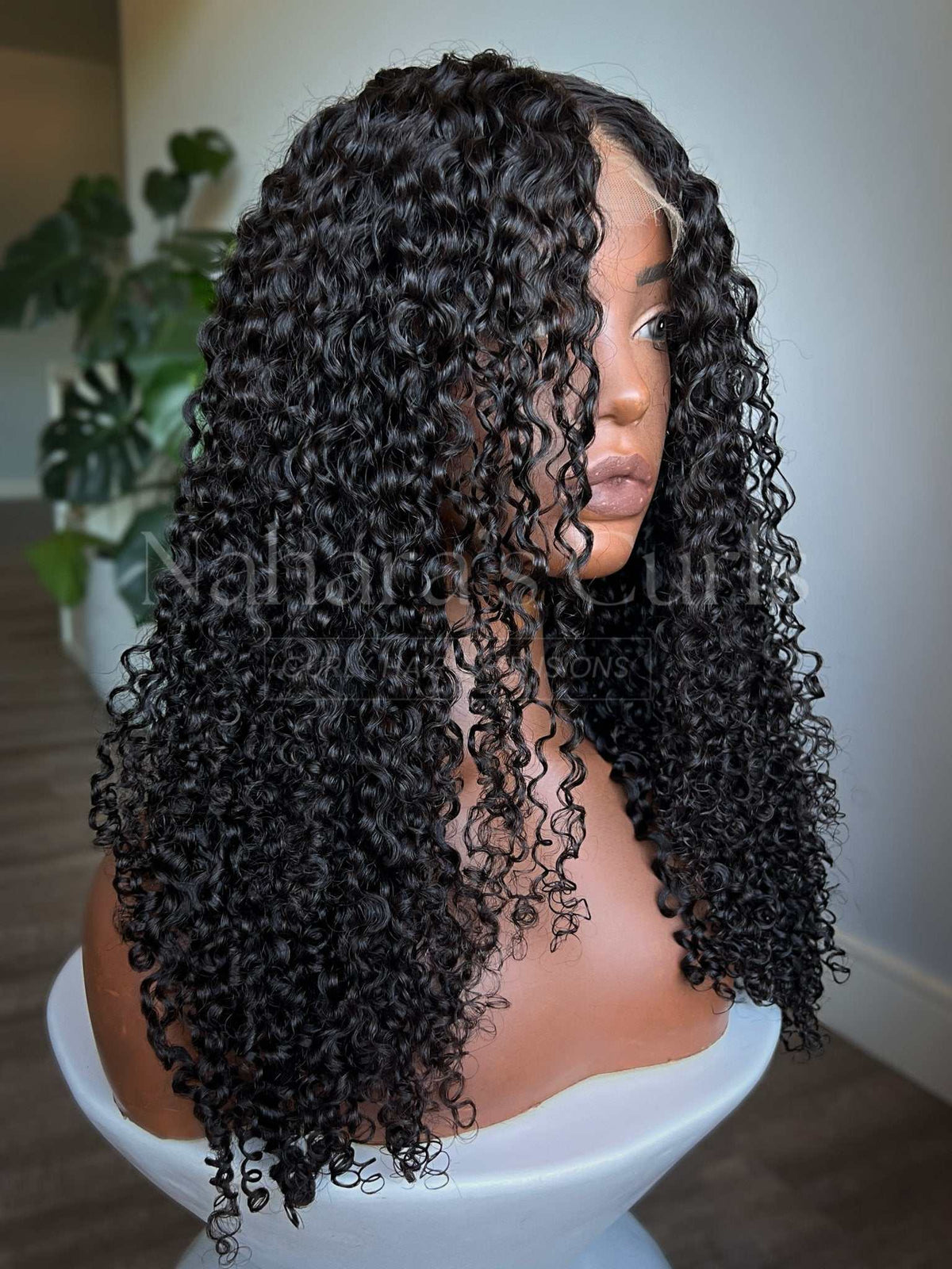 Amala loose curl lace front wig parted at the front to show the 13x6 HD lace