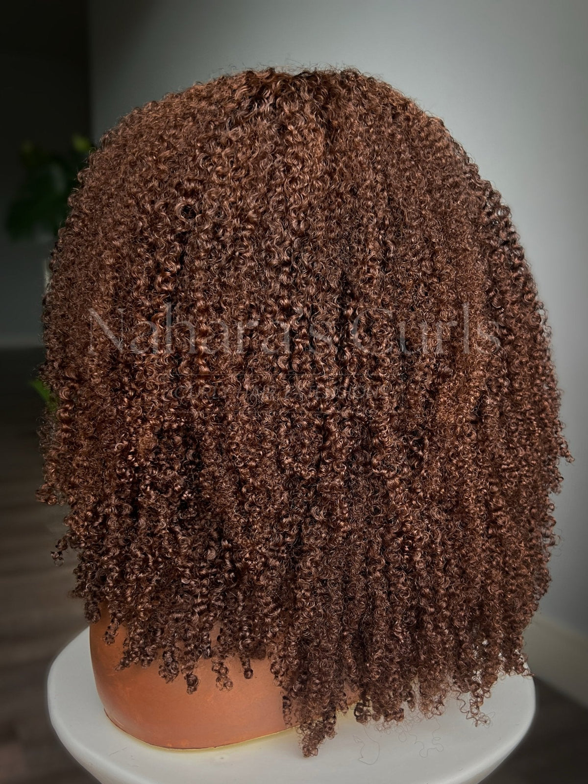 Back view of the Aruna custom wig showing curl volume and 20 inch length