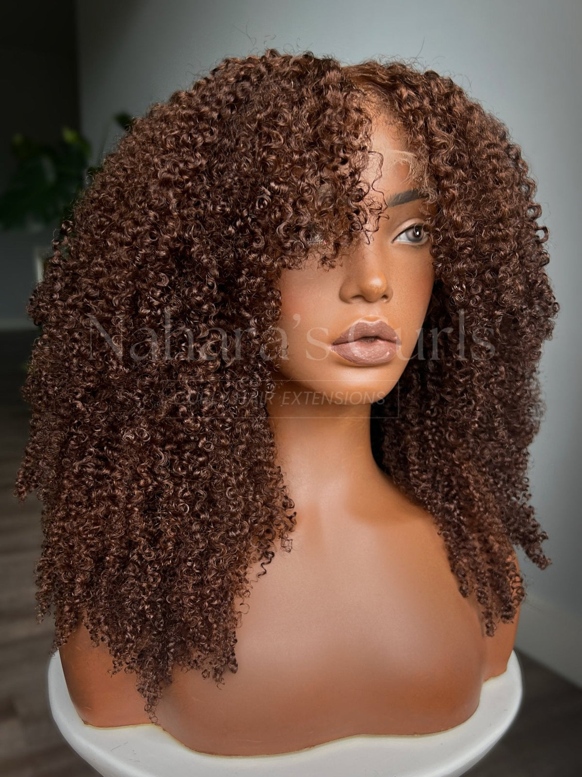 Angled view of the Aruna ginger curly wig showing how the curls stack and move