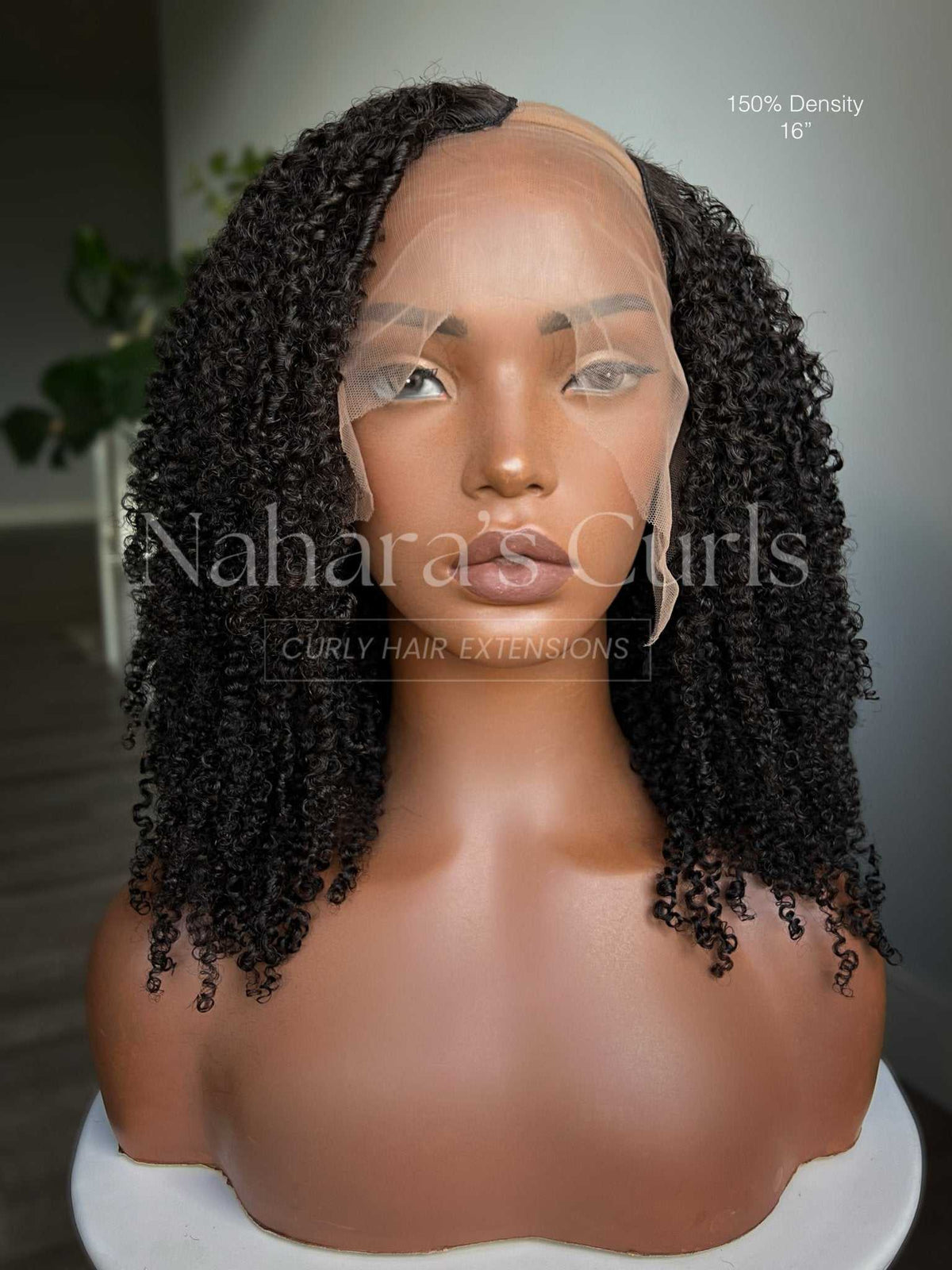 Aura Left U-Part Wig with springy, defined kinky curls and a soft side part, front view