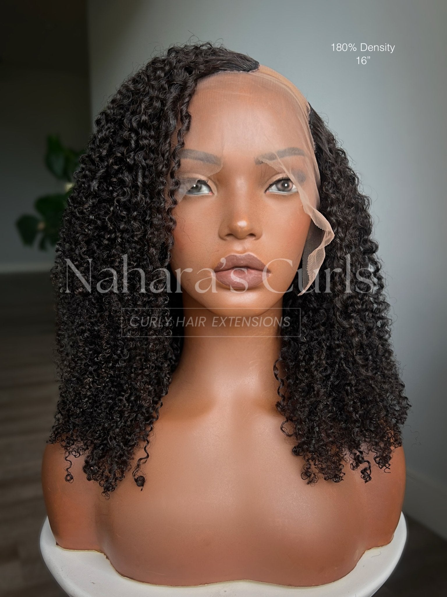 Aura Left U-Part Wig front view with defined curls on mannequin