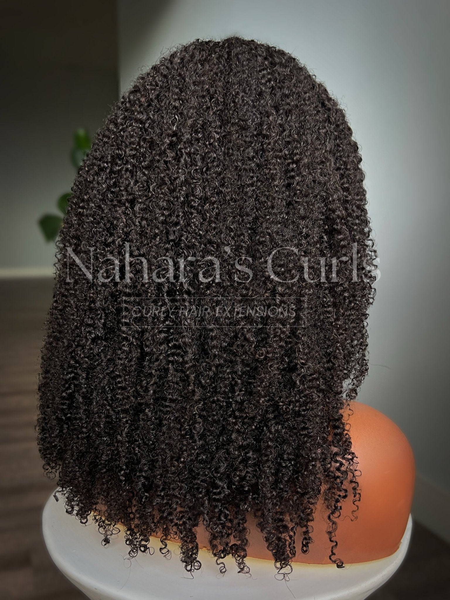 Back view of Aura Left U-Part Wig showing layered curl shape