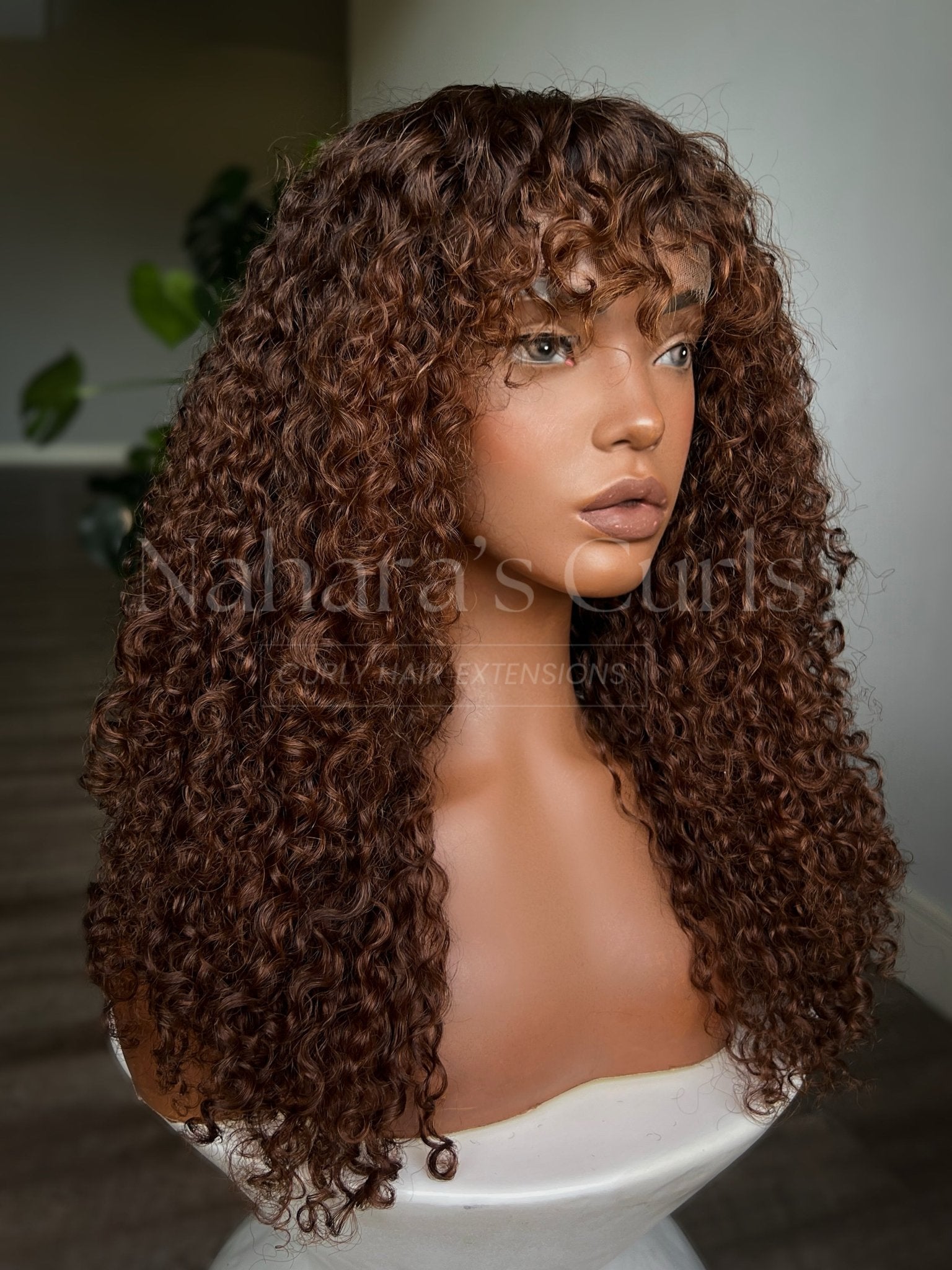 Three-quarter view of a long bohemian wave wig with flowing curls, brown balayage, and HD lace front