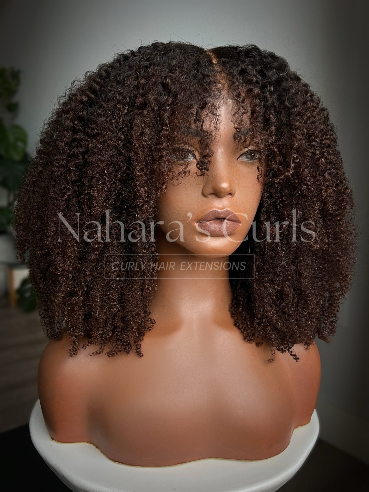 Angle view of the Ishani 13 by 6 HD Contour Lace Front Wig showcasing textured curls and movement