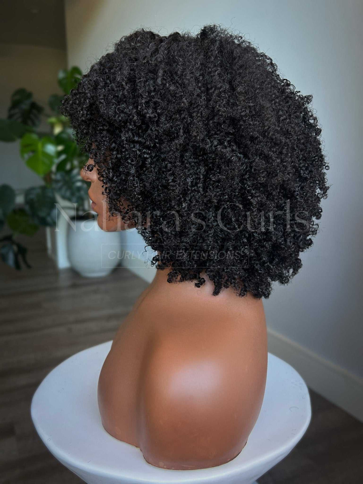 Side view of the VĪRYA wig showing coil volume through the crown and sides