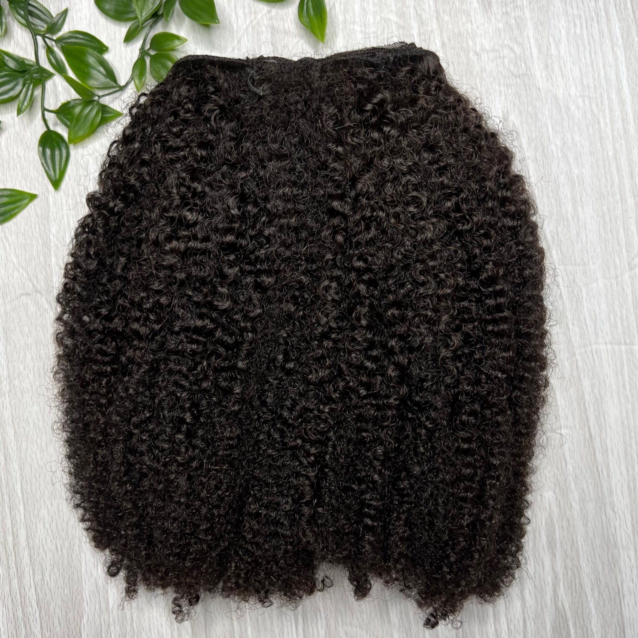 Coily Taj Clip-Ins with natural volume and texture for curly and coily hair types.