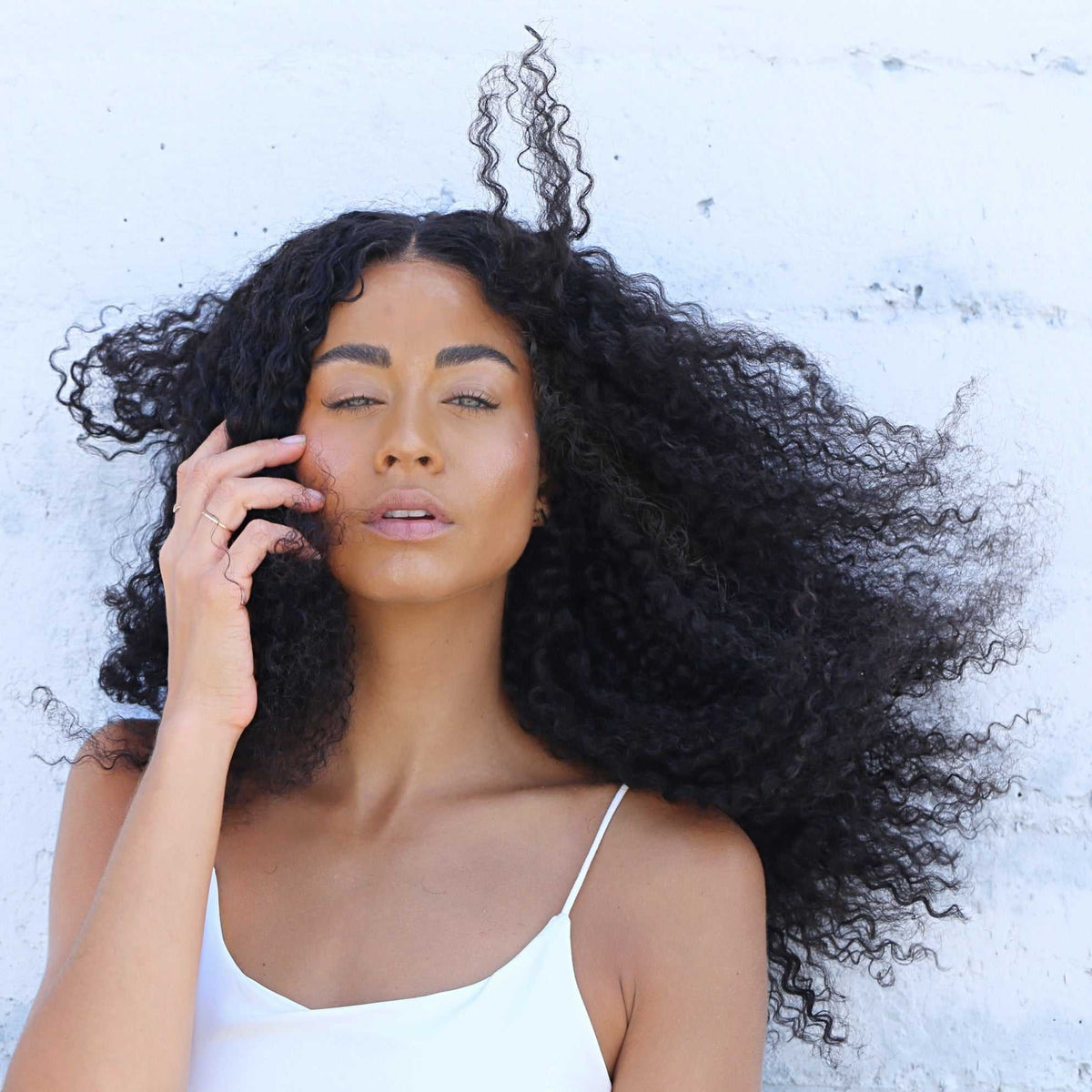 Model wearing the Tula Amplified spiral curl lace front wig with full, bouncy curls