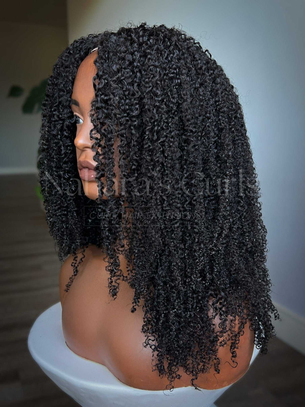 Aura kinky curly U-part wig showing natural volume and defined curls