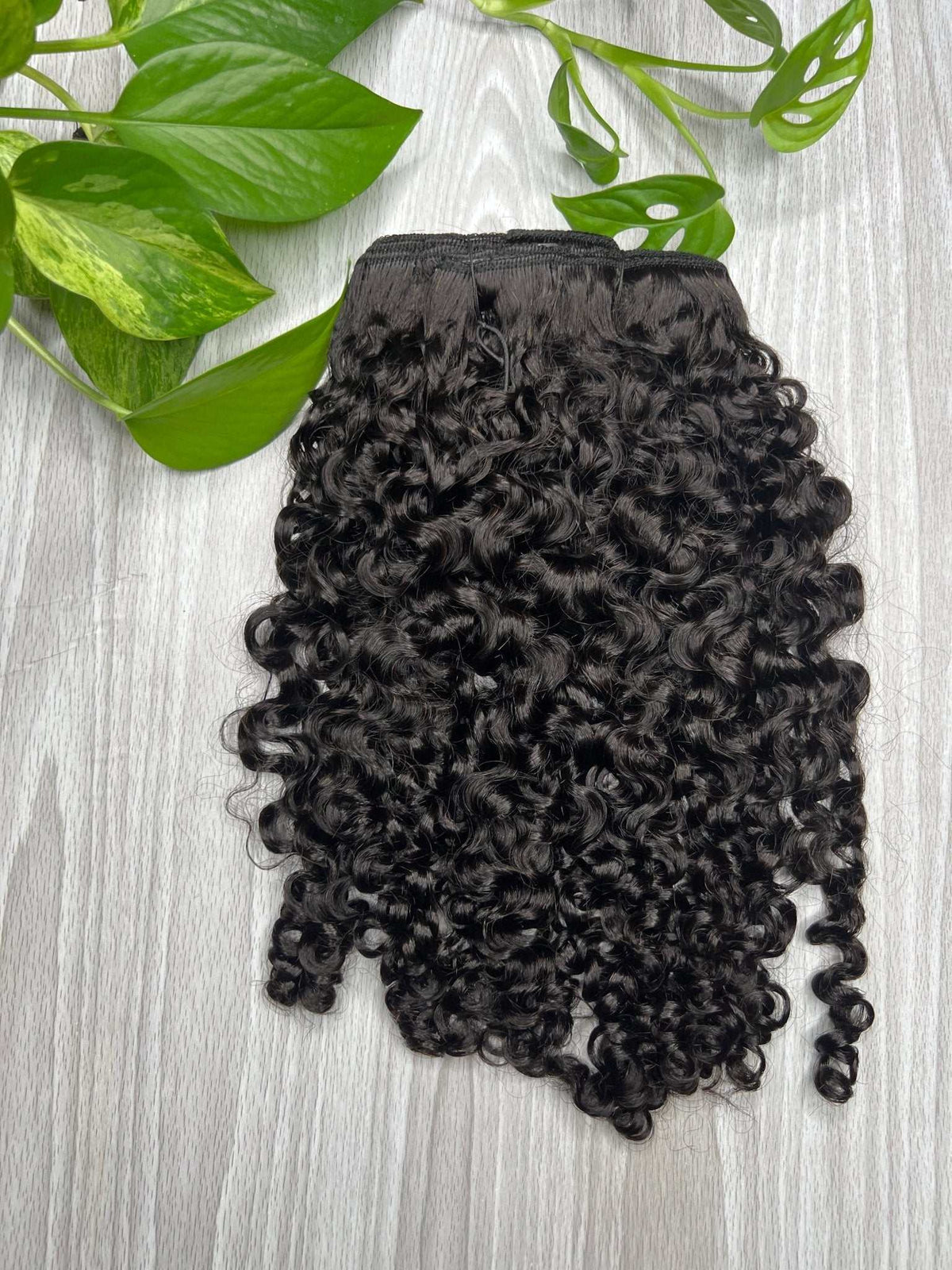 Amala loose curl clip-in extensions showing round curl shape and volume