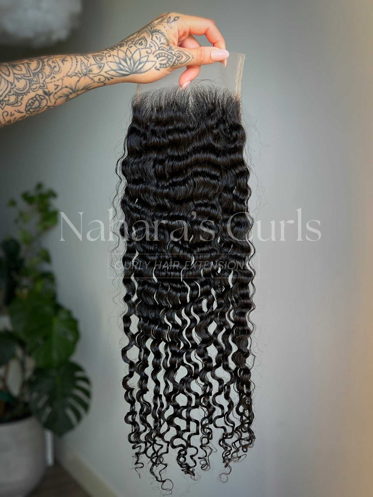 Amala loose curl lace closure showing the 5x5 HD light brown lace and curl length