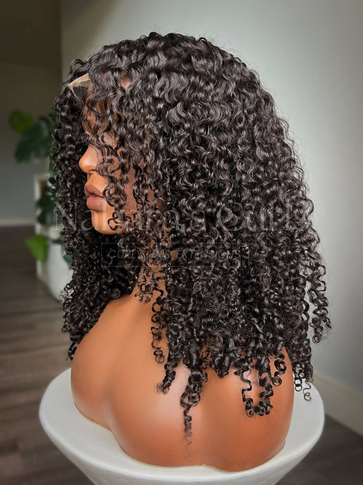 Amala curls falling past the shoulders with natural lift at the root
