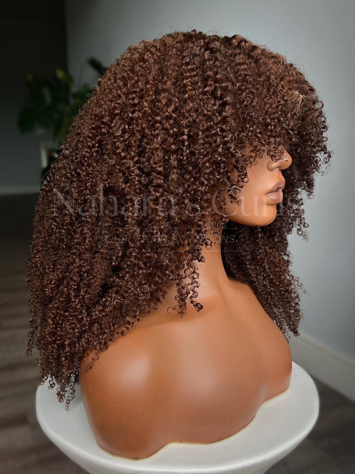 Side view of the Aruna wig showing the layered cut and warm ginger color from root to end
