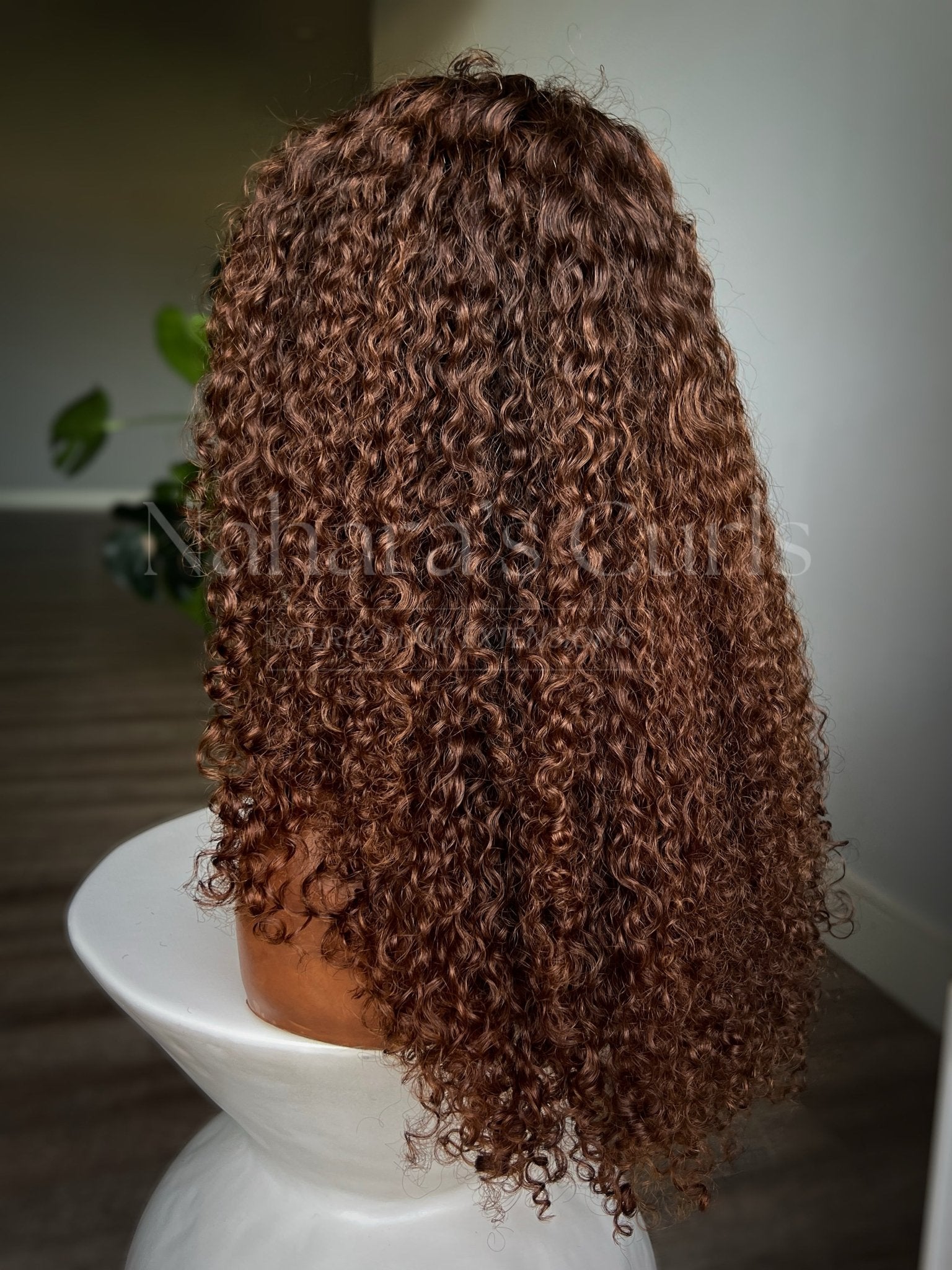Back view of a long wet and wavy human hair wig showing loose beach waves, soft volume, and copper brown balayage