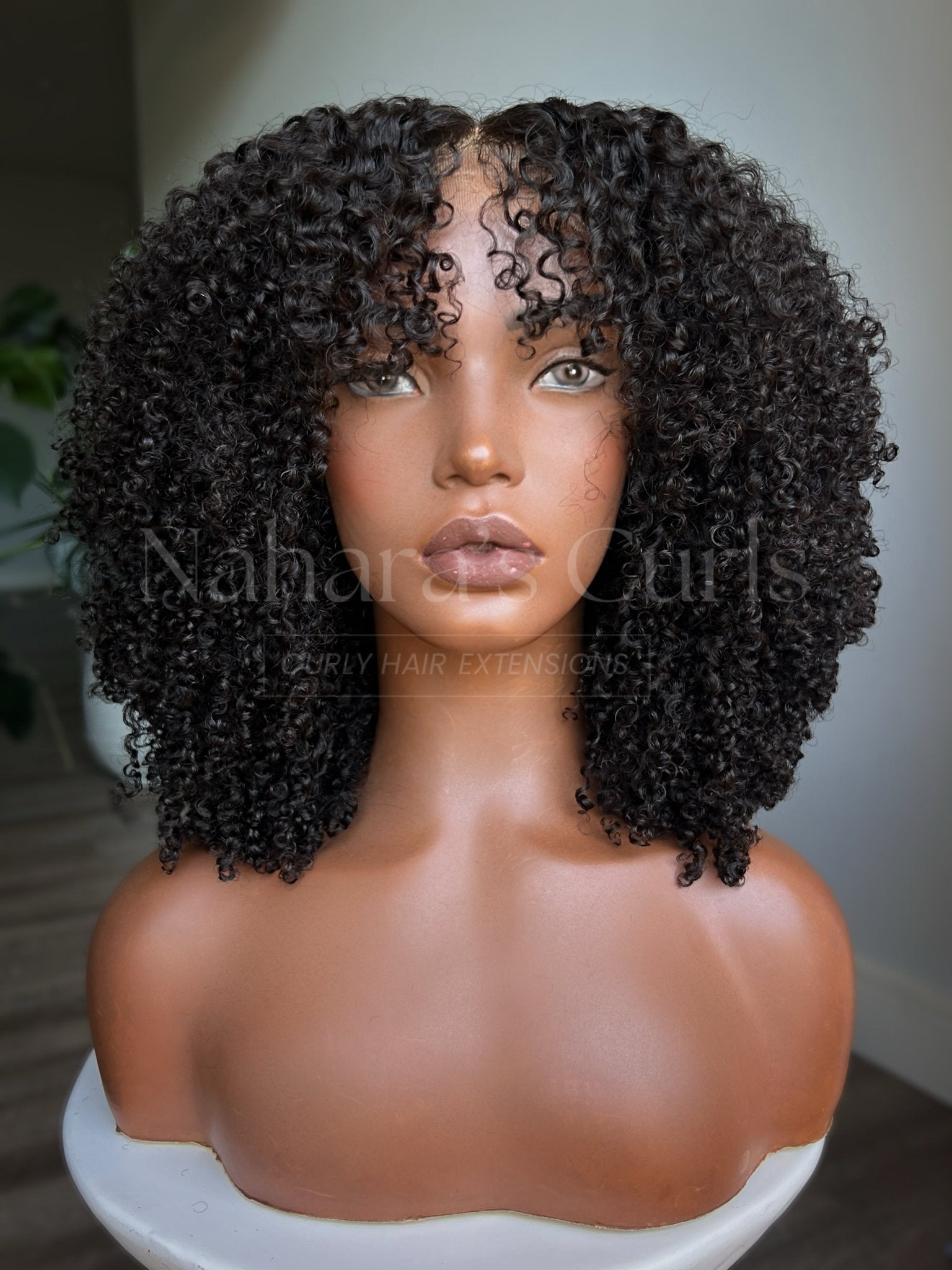  Front view of kinky curly HD lace front human hair wig with defined coily curls
